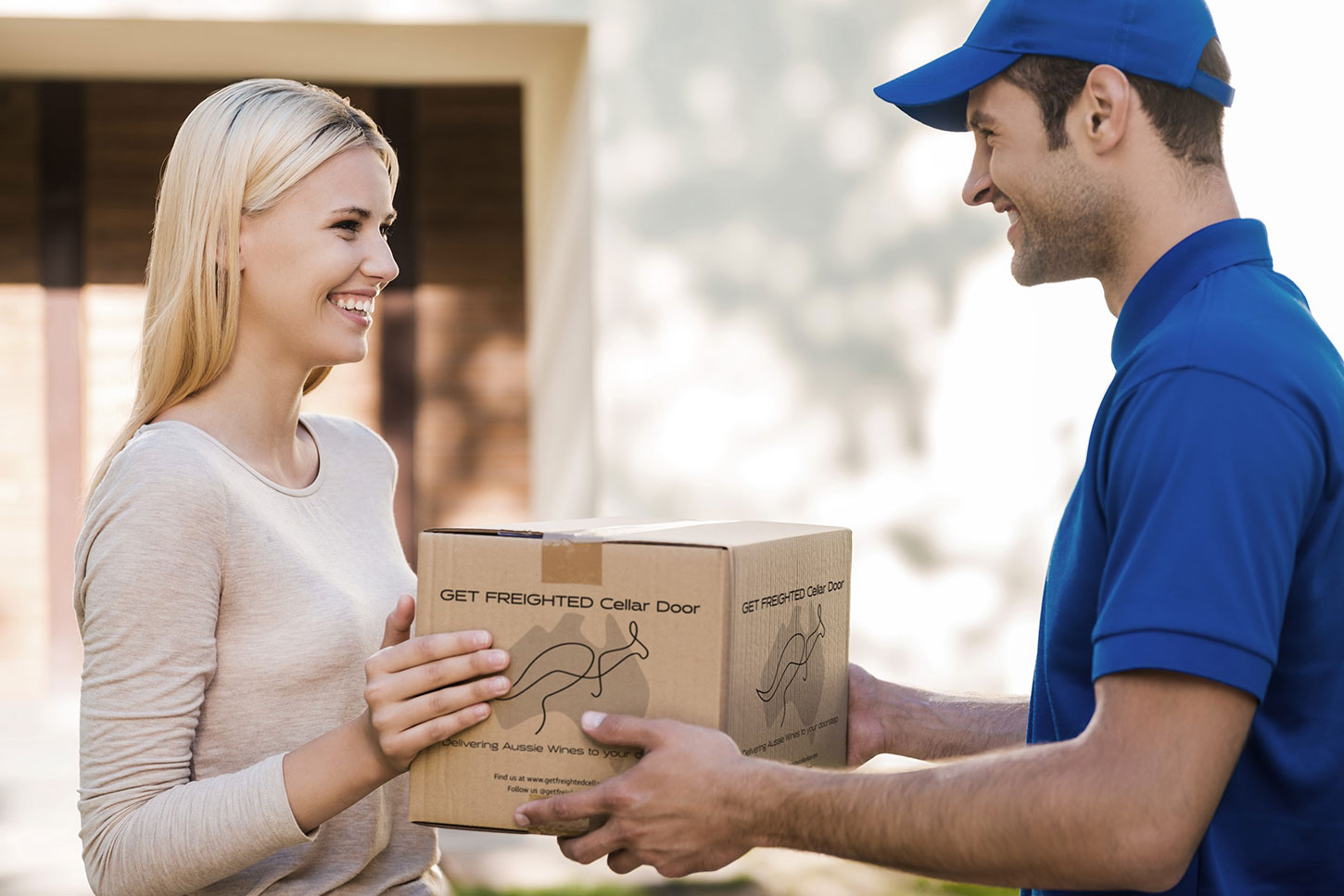 Happy woman receiving GET FREIGHTED Cellar Door delivery.